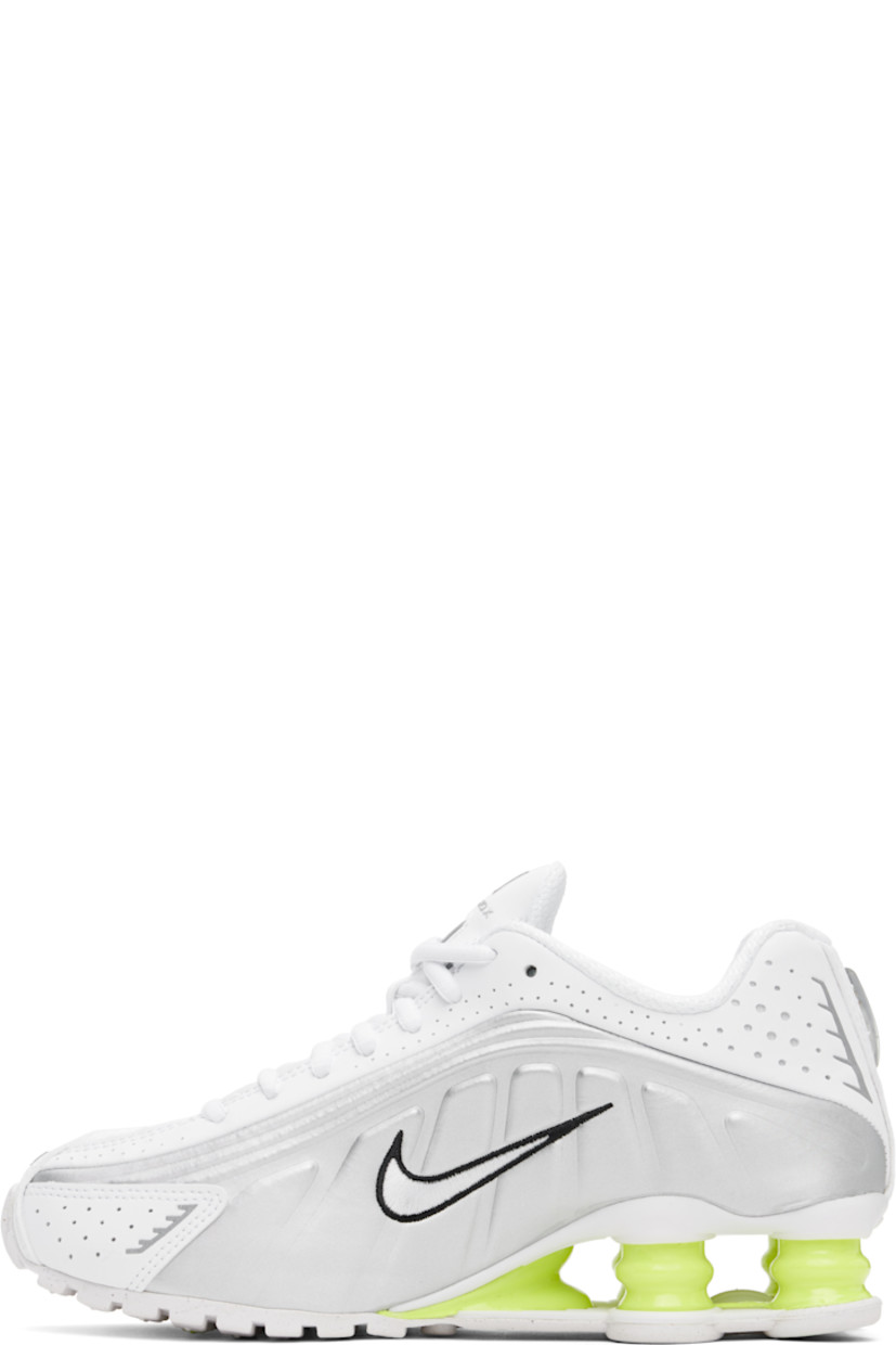 Low-top textured faux-leather and mesh sneakers in white and silver tone.

· Perforations and reflective trim throughout
· Lace-up closure
· Logo bonded at padded tongue
· Logo appliqué at tongue
· Padded collar
· Swoosh embroidered at sides
· Mesh lining
· Nike Shox units at midsole
· Treaded rubber sole

Please note that this item may be shipped only within North America.

Supplier color: White/Metallic silver/Volt/White