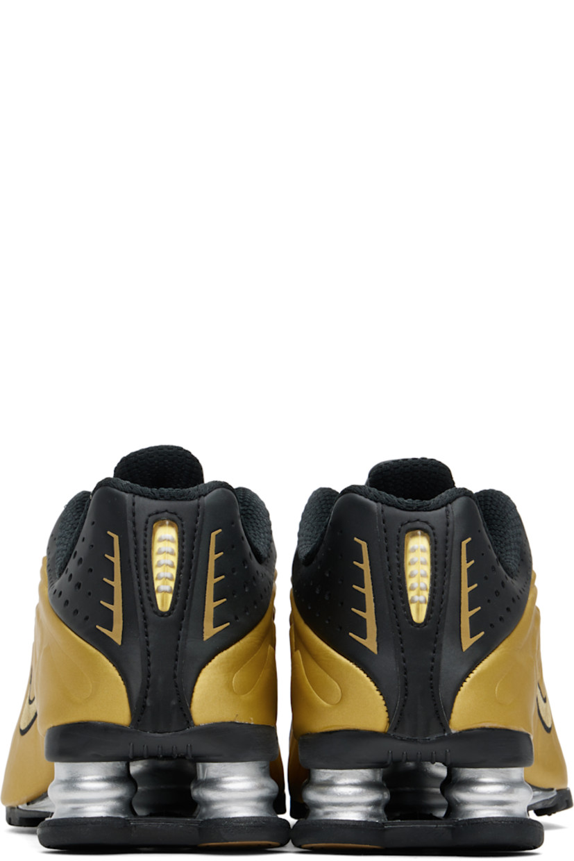 Low-top textured faux-leather and mesh sneakers in black and gold tone.

· Perforations and reflective trim throughout
· Lace-up closure
· Logo bonded at padded tongue
· Logo appliqué at tongue
· Padded collar
· Swoosh embroidered at sides
· Mesh lining
· Nike Shox units at midsole
· Treaded rubber sole

Please note that this item may be shipped only within North America.

Supplier color: Black/Metallic gold