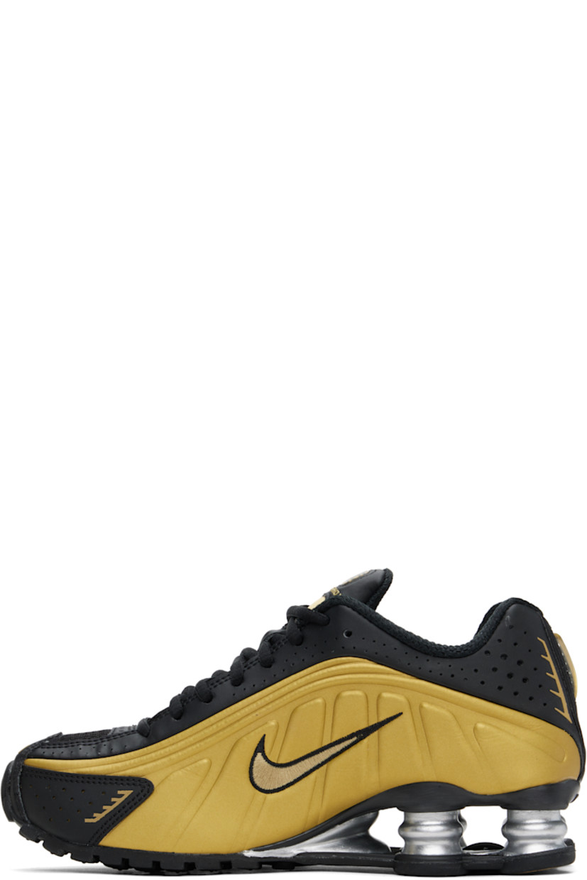 Low-top textured faux-leather and mesh sneakers in black and gold tone.

· Perforations and reflective trim throughout
· Lace-up closure
· Logo bonded at padded tongue
· Logo appliqué at tongue
· Padded collar
· Swoosh embroidered at sides
· Mesh lining
· Nike Shox units at midsole
· Treaded rubber sole

Please note that this item may be shipped only within North America.

Supplier color: Black/Metallic gold