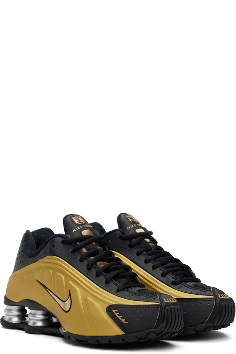 Low-top textured faux-leather and mesh sneakers in black and gold tone.

· Perforations and reflective trim throughout
· Lace-up closure
· Logo bonded at padded tongue
· Logo appliqué at tongue
· Padded collar
· Swoosh embroidered at sides
· Mesh lining
· Nike Shox units at midsole
· Treaded rubber sole

Please note that this item may be shipped only within North America.

Supplier color: Black/Metallic gold