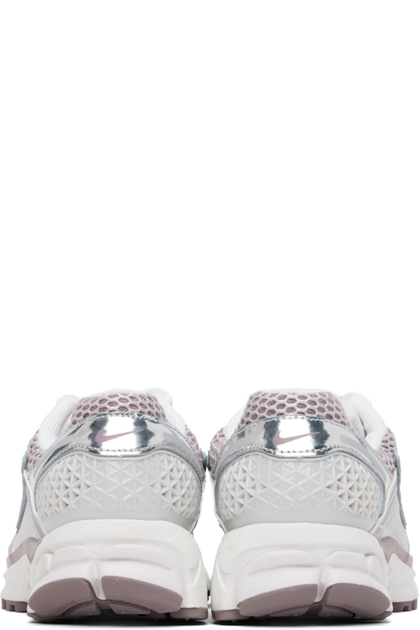 Low-top mesh, buffed leather, and faux-leather sneakers in white and silver tone.

· Reflective trim throughout
· Lace-up closure
· Logo patch at padded tongue
· Padded collar
· Swoosh appliqué and mesh overlay at sides
· Swoosh printed at heel tab
· Air Zoom unit at Cushlon foam rubber midsole
· Treaded rubber sole

Please note that this item may be shipped only within North America.

Supplier color: Vast Grey/Platinum Violet/Taupe Grey/Metallic Silver