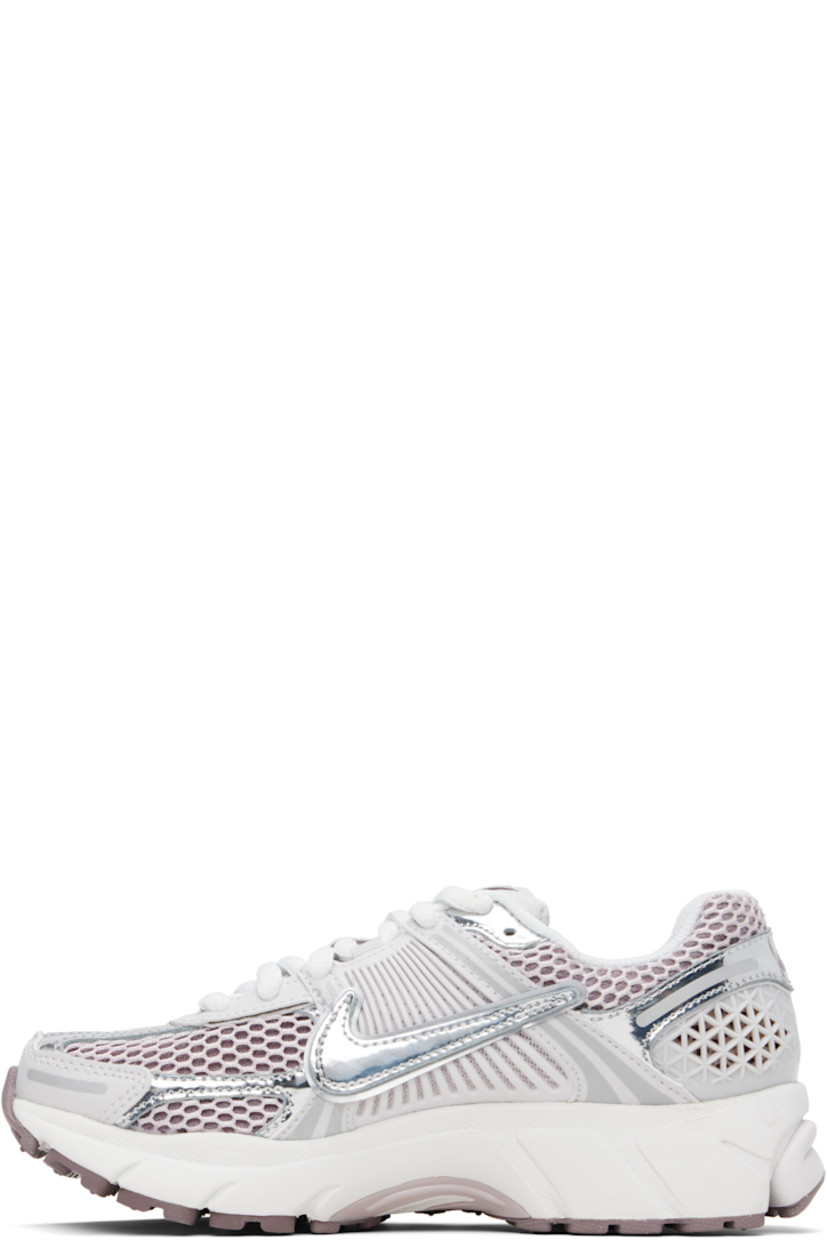 Low-top mesh, buffed leather, and faux-leather sneakers in white and silver tone.

· Reflective trim throughout
· Lace-up closure
· Logo patch at padded tongue
· Padded collar
· Swoosh appliqué and mesh overlay at sides
· Swoosh printed at heel tab
· Air Zoom unit at Cushlon foam rubber midsole
· Treaded rubber sole

Please note that this item may be shipped only within North America.

Supplier color: Vast Grey/Platinum Violet/Taupe Grey/Metallic Silver