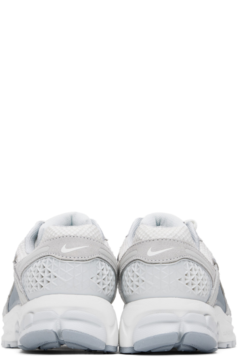Low-top mesh, suede, and buffed faux-leather sneakers in white and gray.

· Reflective trim throughout
· Lace-up closure
· Logo patch at padded tongue
· Padded collar
· Rubberized overlay at sides and heel
· Swoosh appliqué at sides
· Swoosh printed at heel tab
· Mesh lining
· Zoom Air cushioning at foam rubber midsole
· Treaded rubber sole

Please note that this item may be shipped only within North America.

Supplier color: Pure platinum/Platinum tint/Wolf grey/Summit white