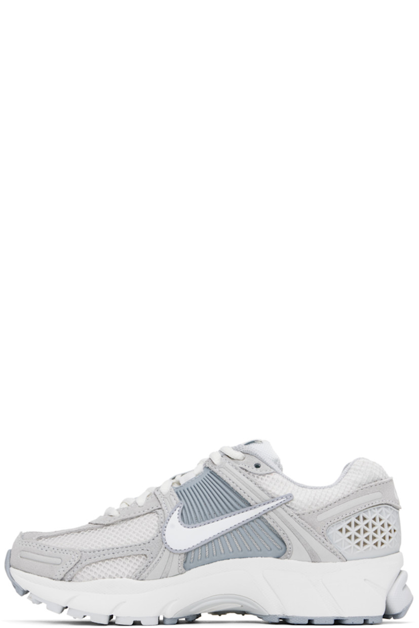 Low-top mesh, suede, and buffed faux-leather sneakers in white and gray.

· Reflective trim throughout
· Lace-up closure
· Logo patch at padded tongue
· Padded collar
· Rubberized overlay at sides and heel
· Swoosh appliqué at sides
· Swoosh printed at heel tab
· Mesh lining
· Zoom Air cushioning at foam rubber midsole
· Treaded rubber sole

Please note that this item may be shipped only within North America.

Supplier color: Pure platinum/Platinum tint/Wolf grey/Summit white