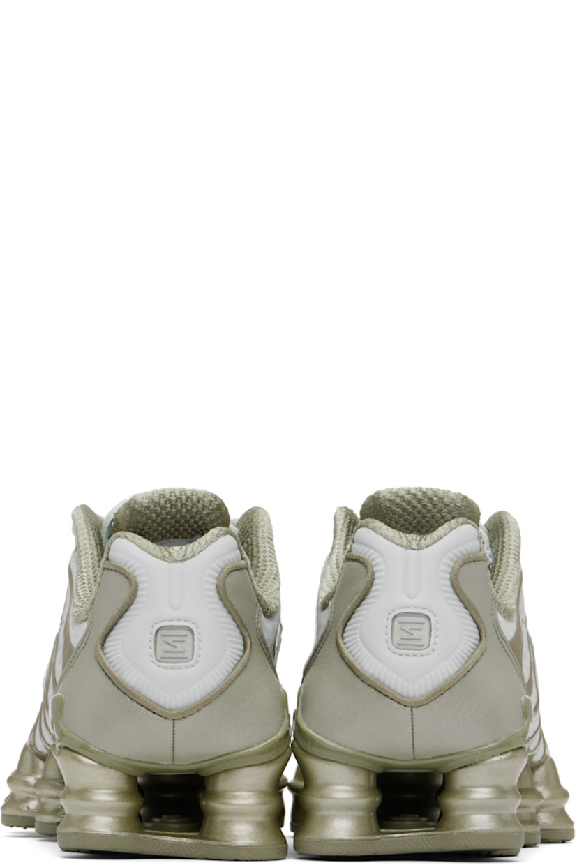 Low-top mesh sneakers in silver tone and khaki.

· Rubberized overlay throughout
· Reflective trim at toe and heel
· Lace-up closure
· Logo bonded at padded tongue
· Inset patch at tongue and heel
· Padded collar
· Swoosh appliqué at sides
· Mesh lining
· Reinforced panel at heel
· Nike Shox units at rubber midsole
· Treaded rubber sole

Please note that this item may be shipped only within North America.

Supplier color: Light silver/Light army/White