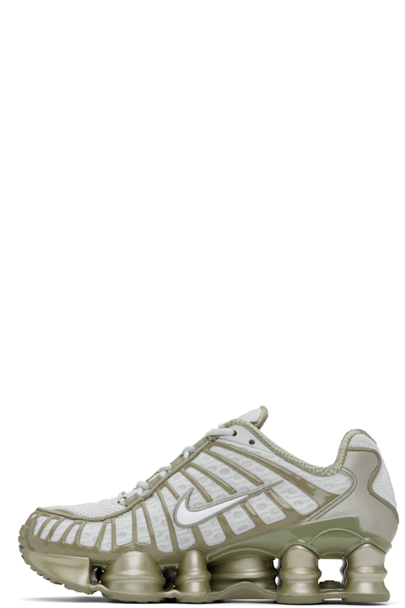 Low-top mesh sneakers in silver tone and khaki.

· Rubberized overlay throughout
· Reflective trim at toe and heel
· Lace-up closure
· Logo bonded at padded tongue
· Inset patch at tongue and heel
· Padded collar
· Swoosh appliqué at sides
· Mesh lining
· Reinforced panel at heel
· Nike Shox units at rubber midsole
· Treaded rubber sole

Please note that this item may be shipped only within North America.

Supplier color: Light silver/Light army/White
