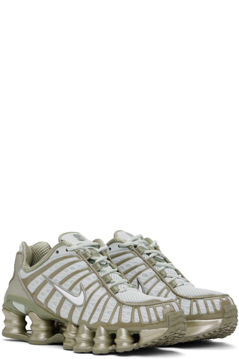 Low-top mesh sneakers in silver tone and khaki.

· Rubberized overlay throughout
· Reflective trim at toe and heel
· Lace-up closure
· Logo bonded at padded tongue
· Inset patch at tongue and heel
· Padded collar
· Swoosh appliqué at sides
· Mesh lining
· Reinforced panel at heel
· Nike Shox units at rubber midsole
· Treaded rubber sole

Please note that this item may be shipped only within North America.

Supplier color: Light silver/Light army/White