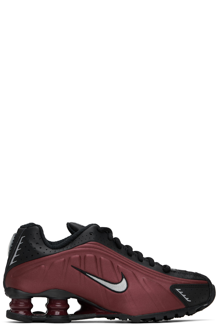 Low-top textured faux-leather and mesh sneakers in burgundy and black.

· Perforations and reflective trim throughout
· Lace-up closure
· Logo bonded at padded tongue
· Gel-filled logo appliqué 
· Padded collar
· Swoosh embroidered at sides
· Mesh lining
· Nike Shox units at midsole
· Treaded rubber sole

Please note that this item may be shipped only within North America.

Supplier color: Black/Team red/Metallic silver