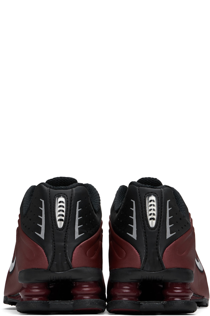 Low-top textured faux-leather and mesh sneakers in burgundy and black.

· Perforations and reflective trim throughout
· Lace-up closure
· Logo bonded at padded tongue
· Gel-filled logo appliqué 
· Padded collar
· Swoosh embroidered at sides
· Mesh lining
· Nike Shox units at midsole
· Treaded rubber sole

Please note that this item may be shipped only within North America.

Supplier color: Black/Team red/Metallic silver