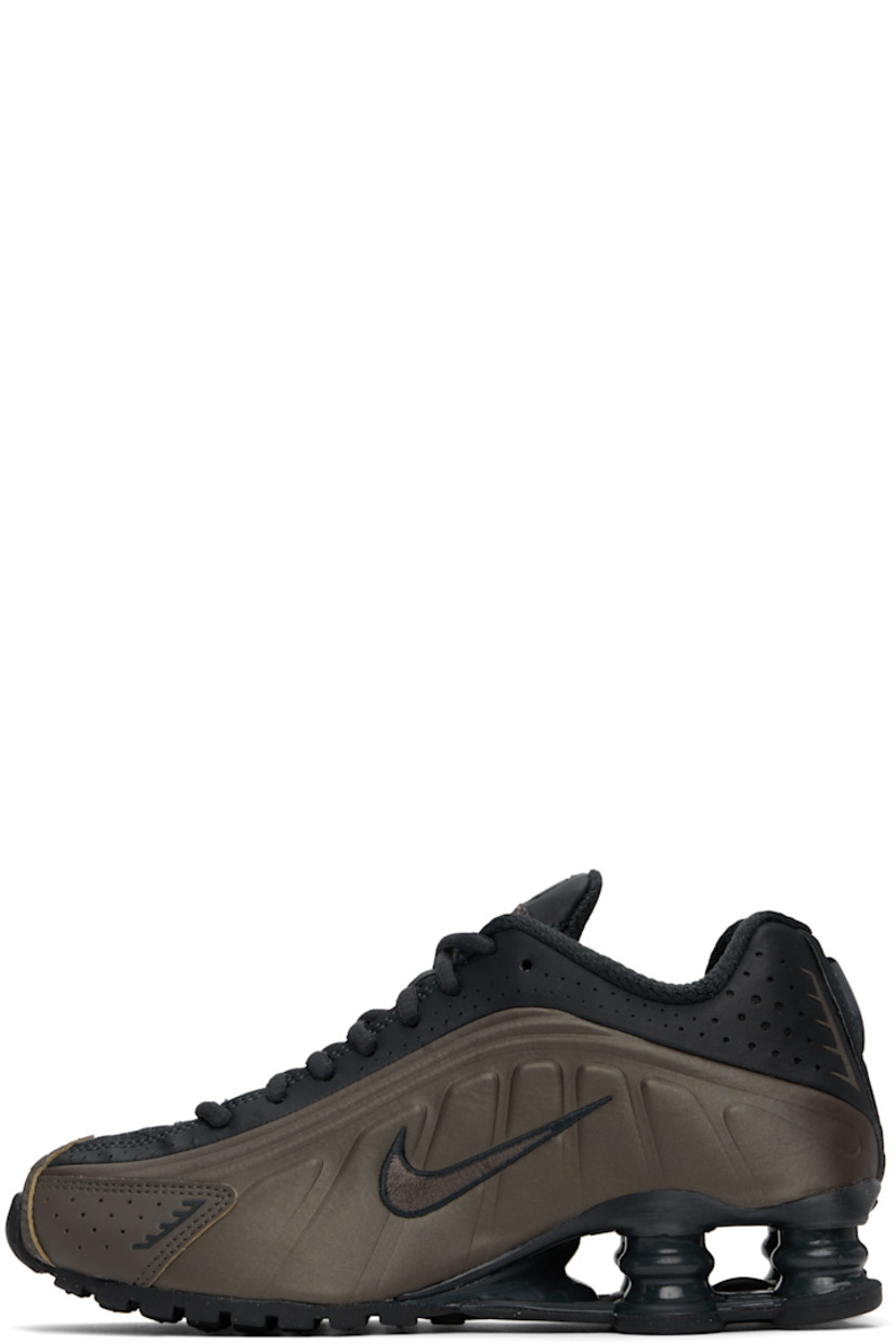 Low-top textured faux-leather and mesh sneakers in khaki and black. 

· Perforations and reflective trim throughout
· Lace-up closure
· Logo bonded at padded tongue
· Gel-filled logo appliqué 
· Padded collar
· Swoosh embroidered at sides
· Mesh lining
· Nike Shox units at midsole
· Treaded rubber sole

Please note that this item may be shipped only within North America.

Supplier color: Off noir/Ironstone/Dark smoke grey/Off noir