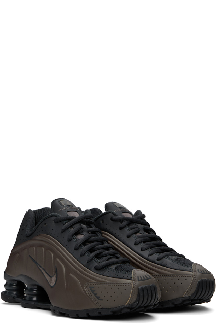 Low-top textured faux-leather and mesh sneakers in khaki and black. 

· Perforations and reflective trim throughout
· Lace-up closure
· Logo bonded at padded tongue
· Gel-filled logo appliqué 
· Padded collar
· Swoosh embroidered at sides
· Mesh lining
· Nike Shox units at midsole
· Treaded rubber sole

Please note that this item may be shipped only within North America.

Supplier color: Off noir/Ironstone/Dark smoke grey/Off noir