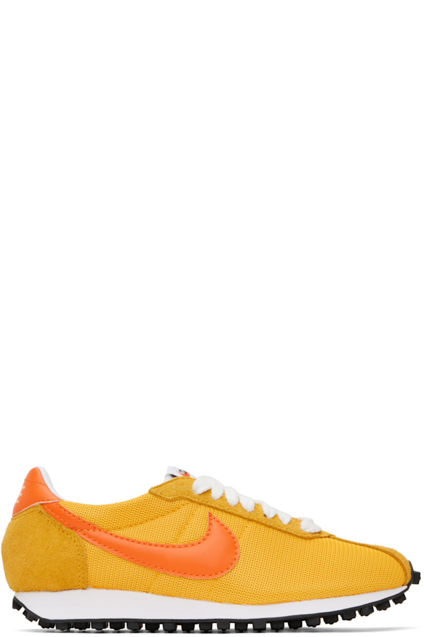 Low-top mesh, suede, and grained faux-leather sneakers in yellow.

· Lace-up closure
· Logo patch at padded tongue
· Padded collar
· Swoosh appliqué at sides
· Logo printed at heel tab
· Buffed leather and jersey lining
· Foam rubber midsole
· Treaded rubber sole

Please note that this item may be shipped only within North America.

Supplier color: University gold/Safety orange