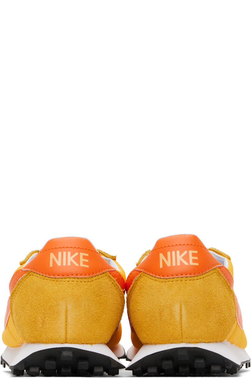 Low-top mesh, suede, and grained faux-leather sneakers in yellow.

· Lace-up closure
· Logo patch at padded tongue
· Padded collar
· Swoosh appliqué at sides
· Logo printed at heel tab
· Buffed leather and jersey lining
· Foam rubber midsole
· Treaded rubber sole

Please note that this item may be shipped only within North America.

Supplier color: University gold/Safety orange