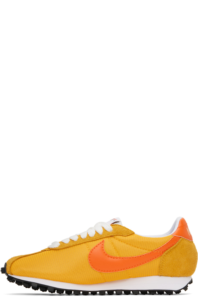 Low-top mesh, suede, and grained faux-leather sneakers in yellow.

· Lace-up closure
· Logo patch at padded tongue
· Padded collar
· Swoosh appliqué at sides
· Logo printed at heel tab
· Buffed leather and jersey lining
· Foam rubber midsole
· Treaded rubber sole

Please note that this item may be shipped only within North America.

Supplier color: University gold/Safety orange