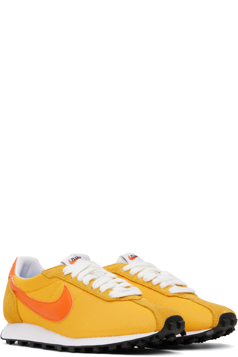 Low-top mesh, suede, and grained faux-leather sneakers in yellow.

· Lace-up closure
· Logo patch at padded tongue
· Padded collar
· Swoosh appliqué at sides
· Logo printed at heel tab
· Buffed leather and jersey lining
· Foam rubber midsole
· Treaded rubber sole

Please note that this item may be shipped only within North America.

Supplier color: University gold/Safety orange