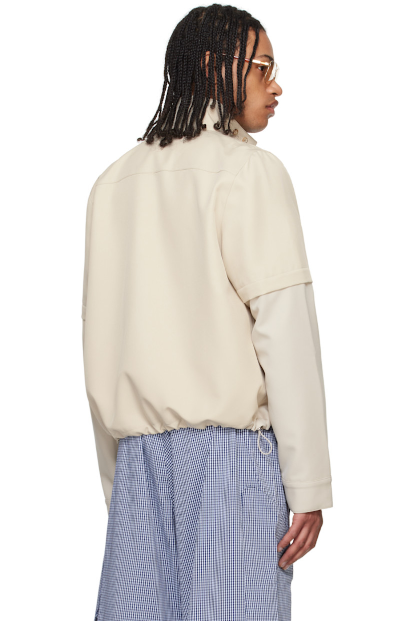 Polyester twill jacket. 

· Paneled construction
· Concealed button tab at stand collar
· Concealed zip closure
· Zip pockets
· Concealed bungee-style drawstring at hem 
· Detachable zip panel at sleeves
· Adjustable button tab at cuffs
· Zip pocket at interior
· Full mesh and plain-woven lining

Supplier color: Tan