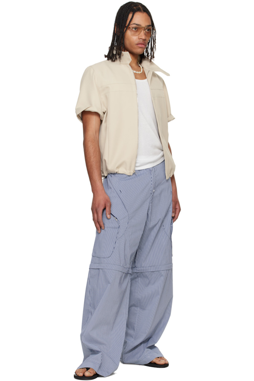 Polyester twill jacket. 

· Paneled construction
· Concealed button tab at stand collar
· Concealed zip closure
· Zip pockets
· Concealed bungee-style drawstring at hem 
· Detachable zip panel at sleeves
· Adjustable button tab at cuffs
· Zip pocket at interior
· Full mesh and plain-woven lining

Supplier color: Tan
