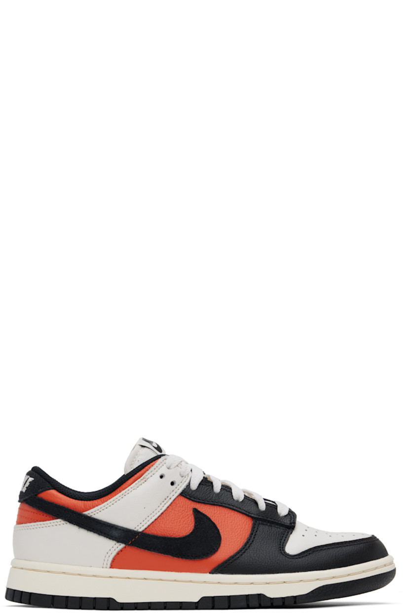 Low-top grained leather sneakers in black and orange.

· Perforated detailing at toe
· Lace-up closure
· Logo patch at padded tongue
· Padded collar
· Swoosh appliqué at sides
· Logo embroidered at heel tab
· Mesh lining
· Treaded rubber sole

Please note that this item may be shipped only within North America.

Supplier color: Phantom/Vintage coral/Pale ivory/Black