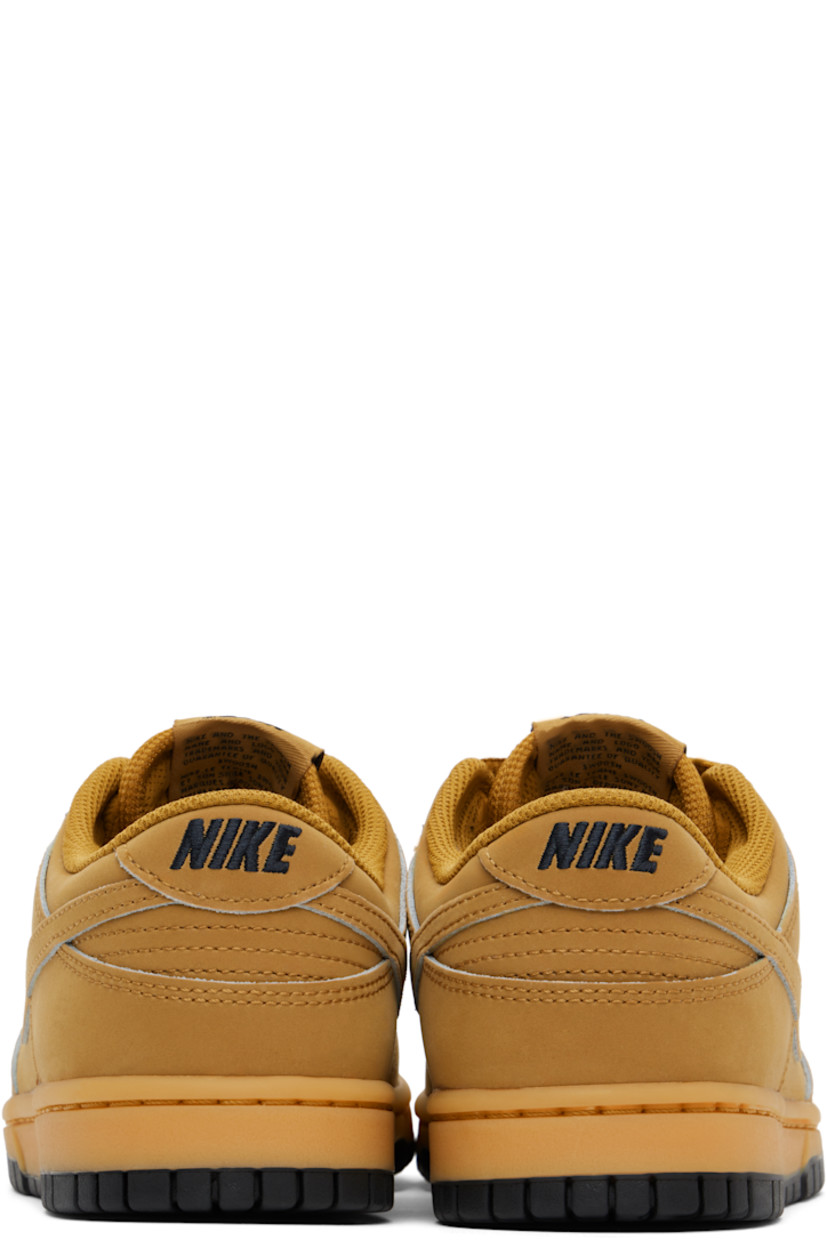 Low-top suede sneakers in tan.

· Perforated detailing at toe
· Lace-up closure
· Logo patch at padded tongue
· Padded collar
· Swoosh appliqué at sides
· Logo embroidered at heel tab
· Mesh lining
· Treaded rubber sole

Please note that this item may be shipped only within North America.

Supplier color: Wheat/Gum yellow/Black/Wheat