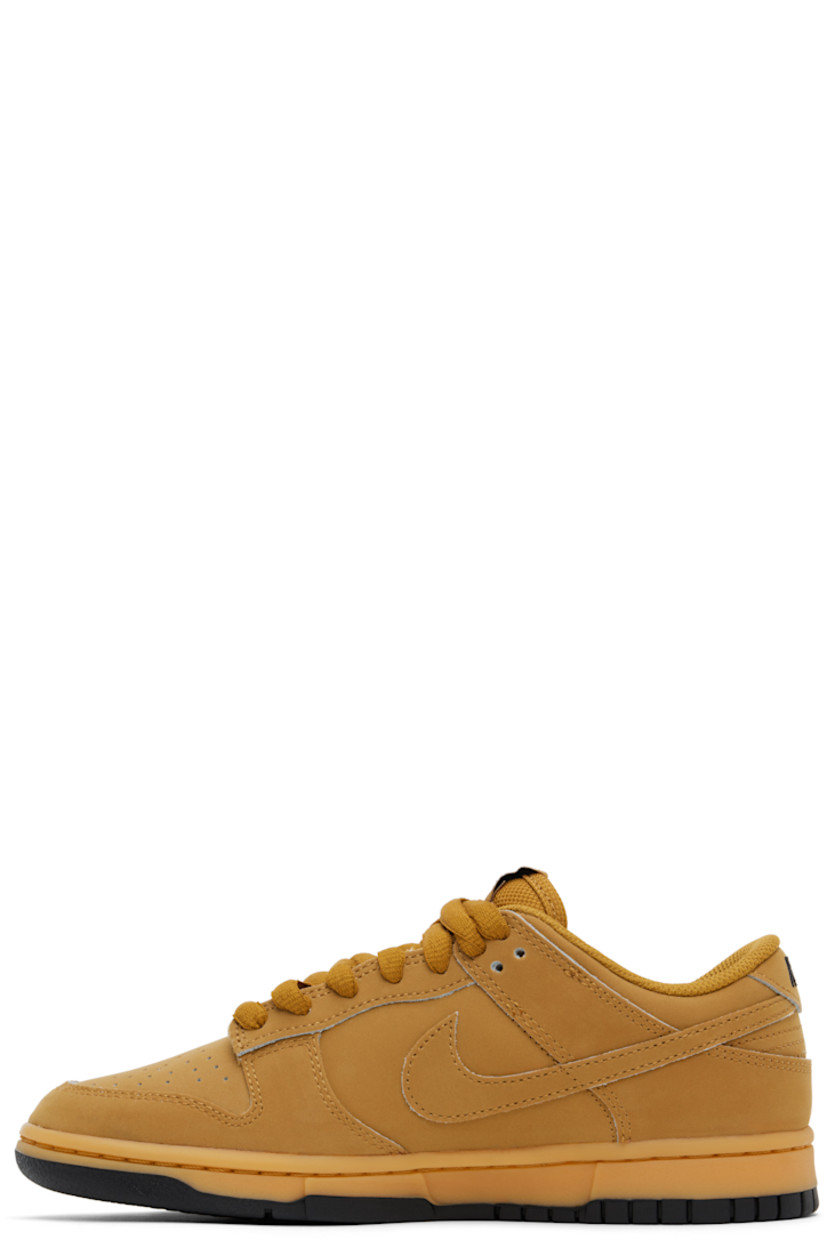 Low-top suede sneakers in tan.

· Perforated detailing at toe
· Lace-up closure
· Logo patch at padded tongue
· Padded collar
· Swoosh appliqué at sides
· Logo embroidered at heel tab
· Mesh lining
· Treaded rubber sole

Please note that this item may be shipped only within North America.

Supplier color: Wheat/Gum yellow/Black/Wheat