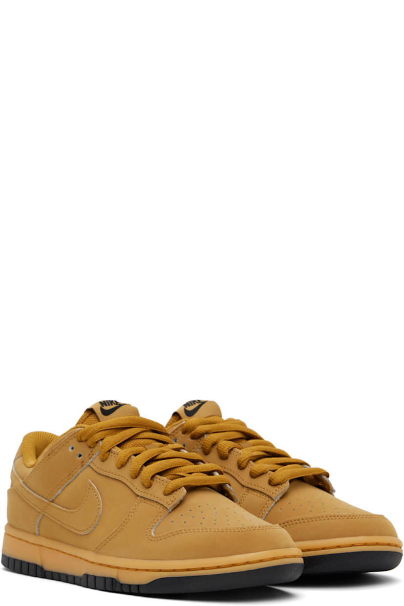 Low-top suede sneakers in tan.

· Perforated detailing at toe
· Lace-up closure
· Logo patch at padded tongue
· Padded collar
· Swoosh appliqué at sides
· Logo embroidered at heel tab
· Mesh lining
· Treaded rubber sole

Please note that this item may be shipped only within North America.

Supplier color: Wheat/Gum yellow/Black/Wheat