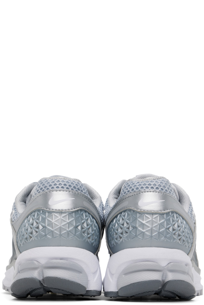 Low-top mesh and buffed faux-leather sneakers in silver tone.

· Reflective trim throughout
· Lace-up closure
· Logo patch at padded tongue
· Padded collar
· Rubberized overlay at sides and heel
· Swoosh appliqué at sides
· Swoosh printed at heel tab
· Mesh lining
· Zoom Air cushioning at foam rubber midsole
· Treaded rubber sole

Please note that this item may be shipped only within North America.

Supplier color: Wolf grey/White