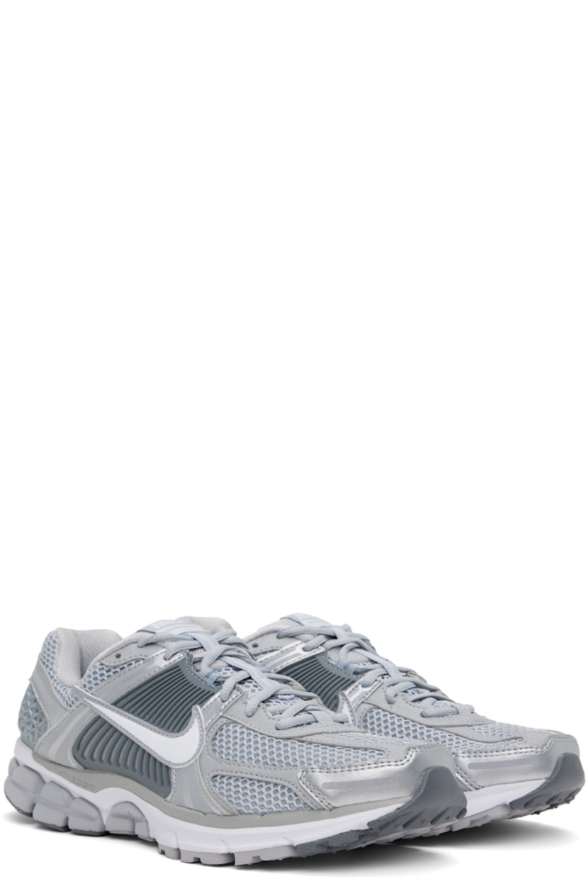 Low-top mesh and buffed faux-leather sneakers in silver tone.

· Reflective trim throughout
· Lace-up closure
· Logo patch at padded tongue
· Padded collar
· Rubberized overlay at sides and heel
· Swoosh appliqué at sides
· Swoosh printed at heel tab
· Mesh lining
· Zoom Air cushioning at foam rubber midsole
· Treaded rubber sole

Please note that this item may be shipped only within North America.

Supplier color: Wolf grey/White