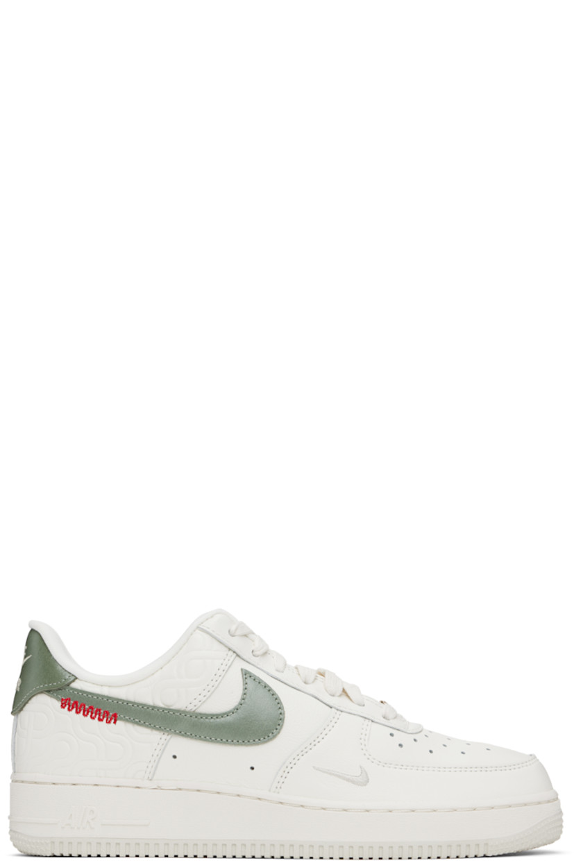 Low-top buffed leather sneakers in off-white.

· Graphic pattern embossed throughout
· Perforated detailing at toe and sides
· Graphic hardware at lace-up closure
· Logo patch at padded tongue
· Padded collar
· Swoosh appliqué at sides
· Logo embroidered at heel tab
· Mesh lining
· Air Sole unit at midsole
· Treaded rubber sole

Please note that this item may be shipped only within North America.

Supplier color: Sail/Light bone/University red/Jade horizon