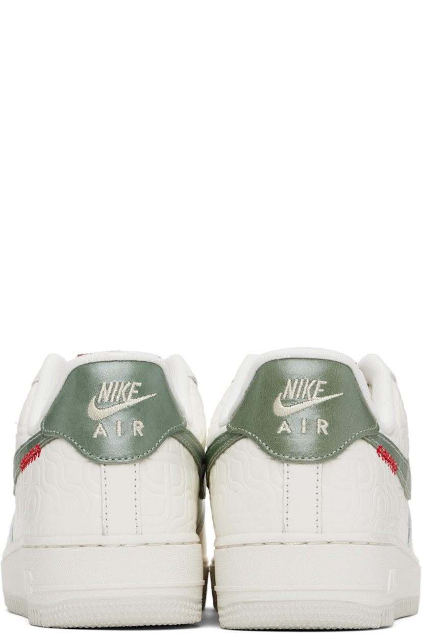 Low-top buffed leather sneakers in off-white.

· Graphic pattern embossed throughout
· Perforated detailing at toe and sides
· Graphic hardware at lace-up closure
· Logo patch at padded tongue
· Padded collar
· Swoosh appliqué at sides
· Logo embroidered at heel tab
· Mesh lining
· Air Sole unit at midsole
· Treaded rubber sole

Please note that this item may be shipped only within North America.

Supplier color: Sail/Light bone/University red/Jade horizon