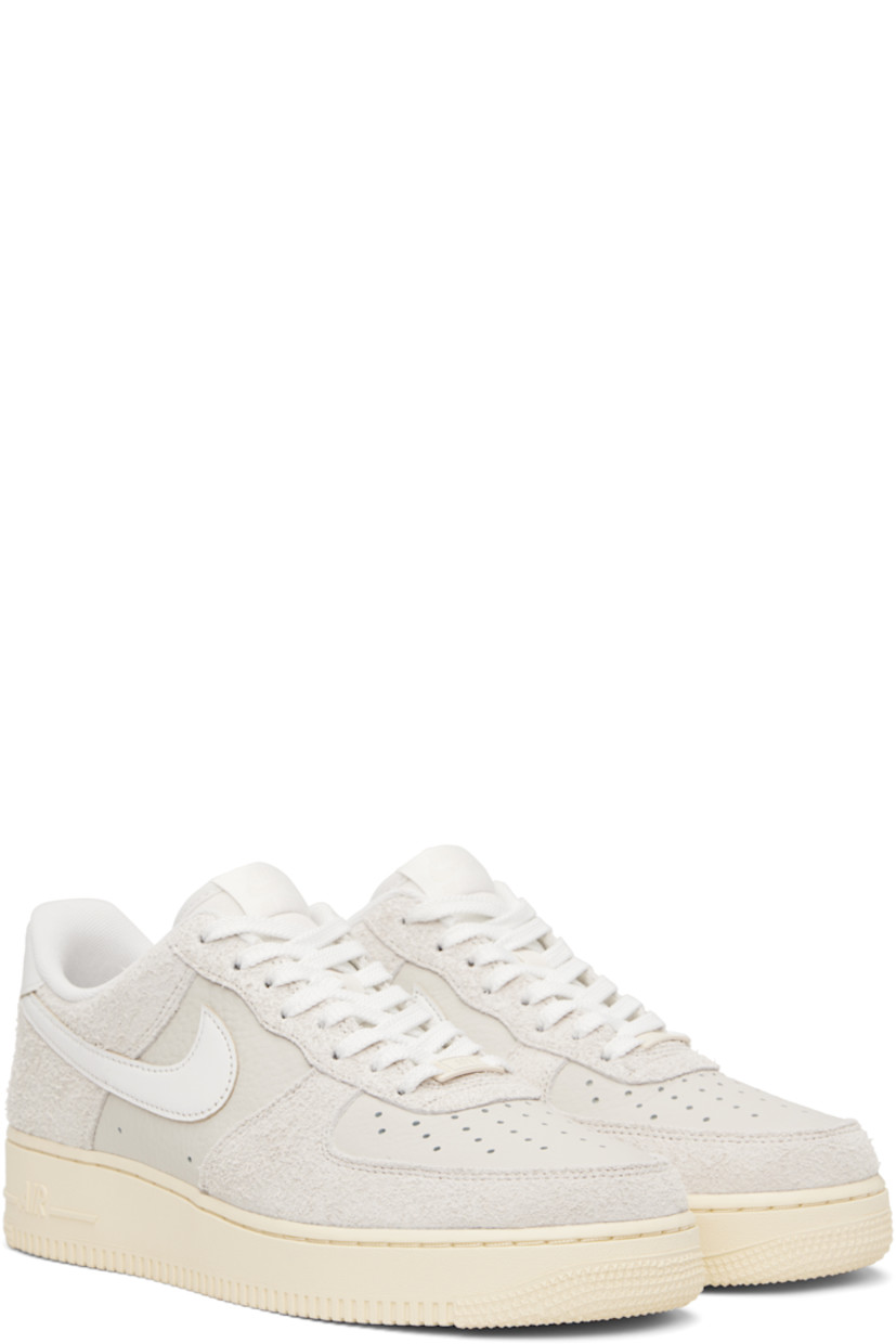 Low-top grained leather and suede sneakers in off-white.

· Perforations throughout
· Logo plaque at lace-up closure
· Logo patch at padded tongue
· Padded collar
· Swoosh appliqué at sides
· Logo embossed at heel tab
· Mesh lining
· Logo embossed at outer midsole
· Treaded rubber sole

Please note that this item may be shipped only within North America.

Supplier color: Phantom/Summit white