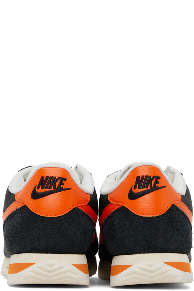 Low-top canvas, suede, and grained faux-leather sneakers in black and orange.

· Lace-up closure
· Logo patch at padded tongue
· Padded collar
· Swoosh appliqué at sides
· Logo embroidered at heel tab
· Mesh lining
· Foam rubber midsole
· Treaded rubber sole

Please note that this item may be shipped only within North America.

Supplier color: Black/Sail/Muslin/Safety orange