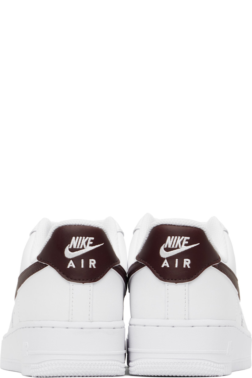 Low-top buffed leather sneakers in white.

· Perforations at toe and sides
· Logo plaque at lace-up closure
· Logo flag at padded tongue
· Padded collar
· Swoosh appliqué at sides
· Logo embroidered at heel tab
· Mesh lining
· Air Sole unit at midsole
· Treaded rubber sole

Please note that this item may be shipped only within North America.

Supplier color: White/White/Burgundy crush