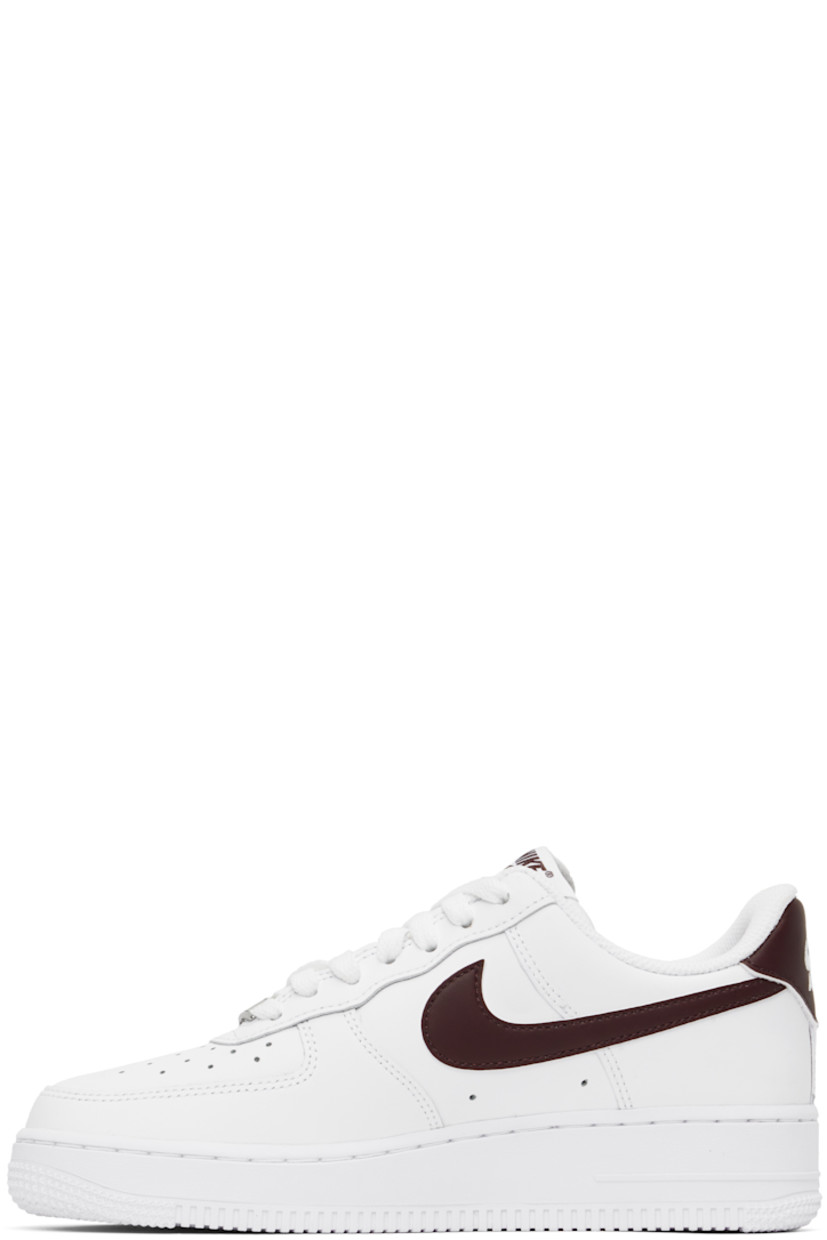 Low-top buffed leather sneakers in white.

· Perforations at toe and sides
· Logo plaque at lace-up closure
· Logo flag at padded tongue
· Padded collar
· Swoosh appliqué at sides
· Logo embroidered at heel tab
· Mesh lining
· Air Sole unit at midsole
· Treaded rubber sole

Please note that this item may be shipped only within North America.

Supplier color: White/White/Burgundy crush