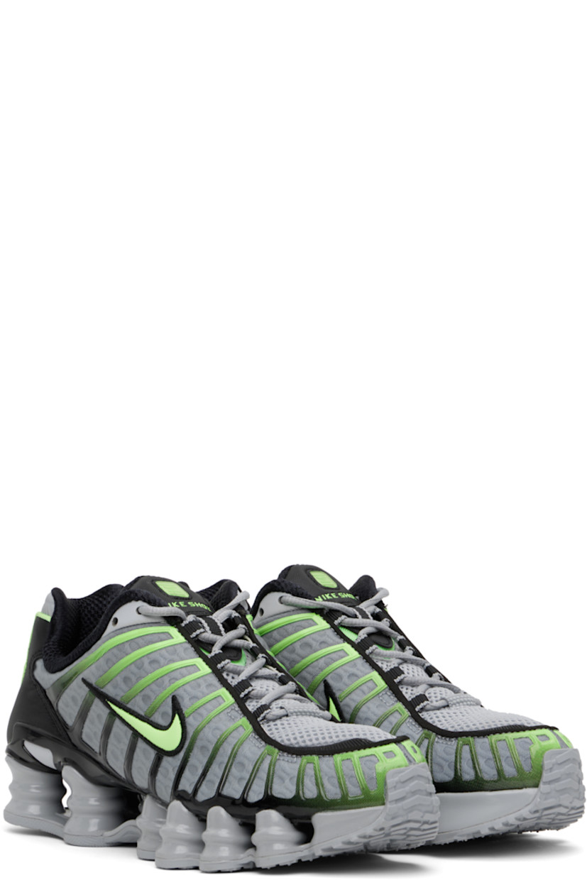Low-top mesh sneakers in gray and green.

· Bonded rubber trim throughout
· Lace-up closure
· Logo bonded at padded tongue
· Inset patch at tongue and heel
· Padded collar
· Swoosh appliqué at sides
· Mesh lining
· Nike Shox units at midsole
· Treaded rubber sole

Please note that this item may be shipped only within North America.

Supplier color: Wolf grey/Lime blast/Black