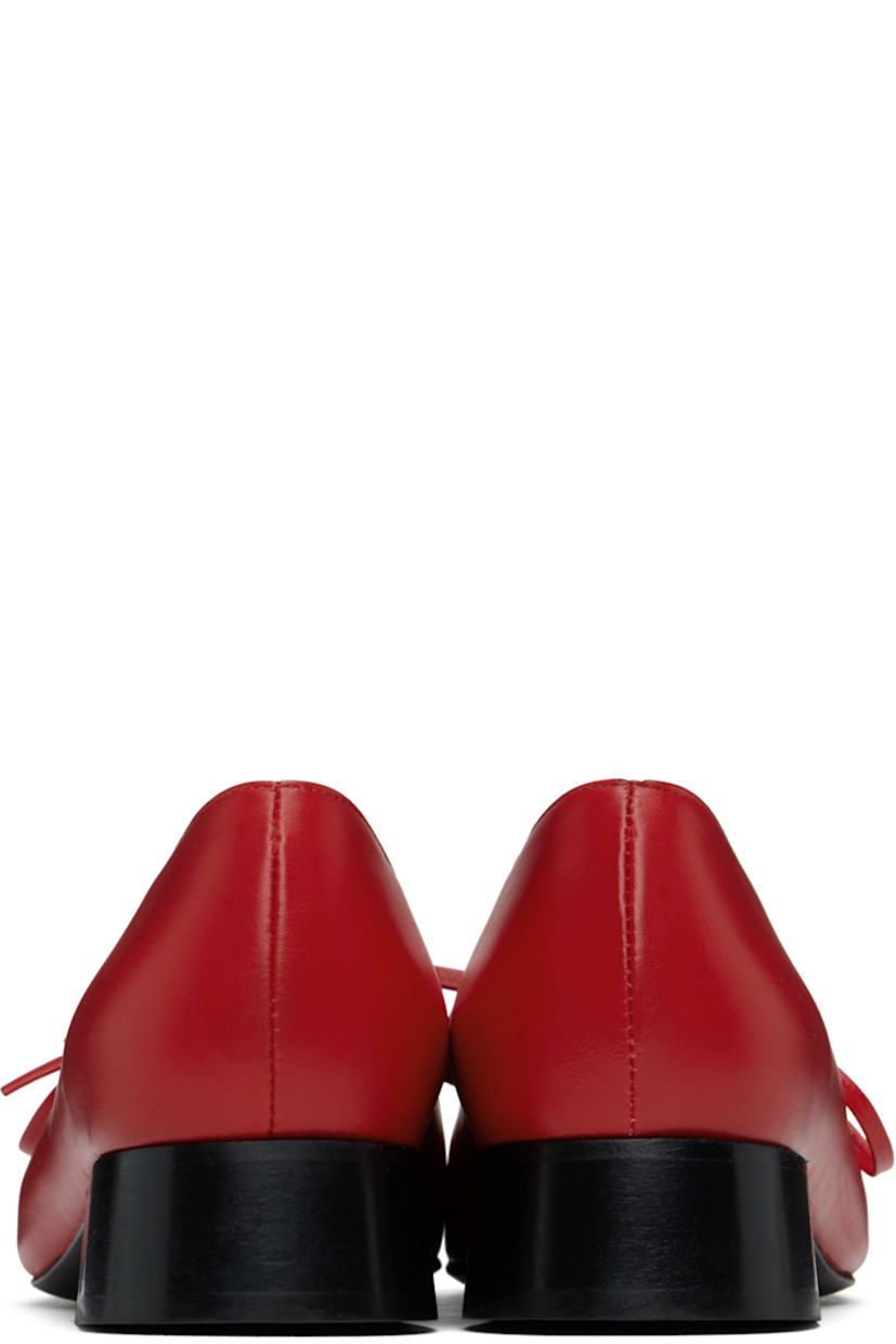 Handcrafted buffed nappa leather Mary Jane-style ballerina flats in red.

· Square toe
· Self-tie bow accents at vamp
· Logo embossed at padded footbed
· Buffed leather and suede lining
· Stacked leather heel with rubber injection
· Polished leather sole
· Heel: H1.25"

Supplier color: Red