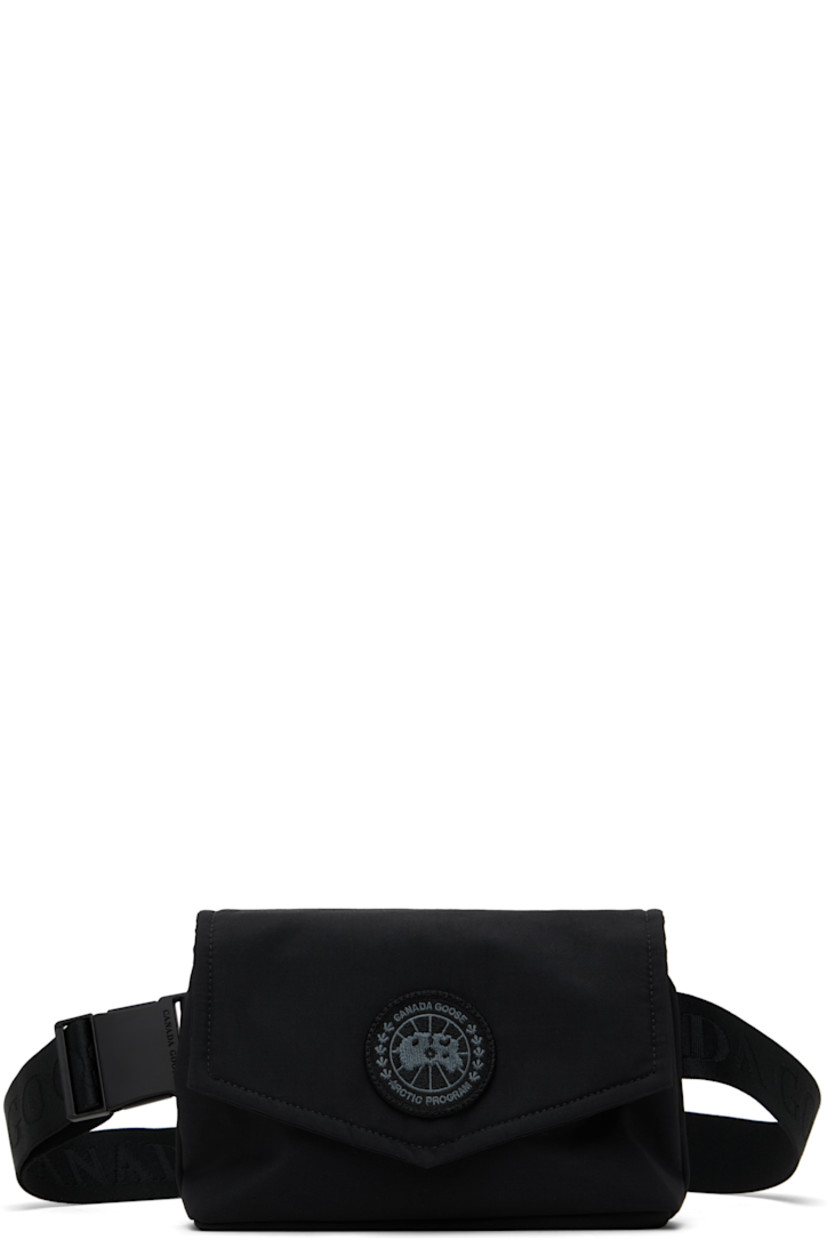 Insulated CORDURA® nylon duck canvas belt bag in black.

· Water-repellent and durable
· Adjustable logo-woven crossbody strap
· Embroidered logo patch at face
· Press-stud flap
· Zip closure
· Patch pocket at interior
· Quilted taffeta lining
· H5.5" x W8.5" x D1.75"

Supplier color: Black
