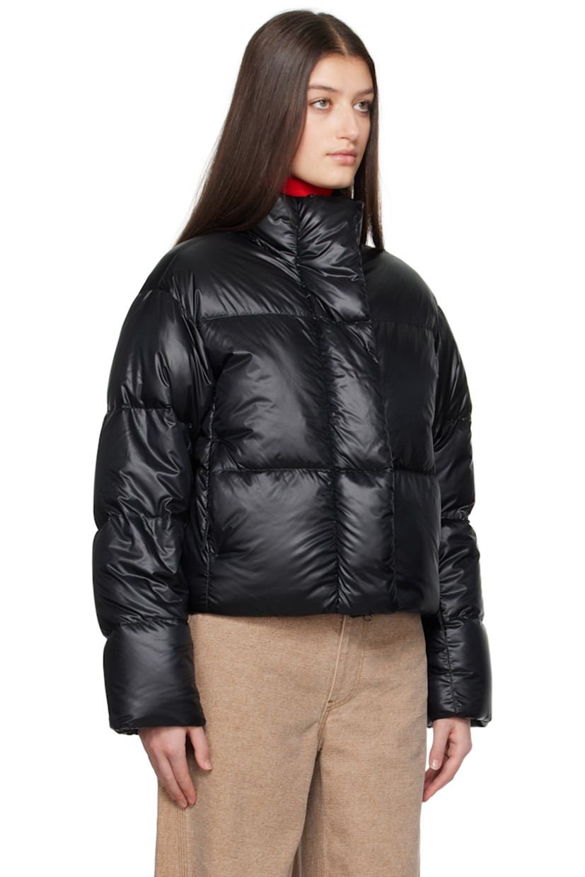 Down-filled and quilted recycled nylon ripstop jacket. Packable, lightweight, water-repellent, and wind-resistant.

· Stand collar
· Two-way zip closure with button placket
· Seam pockets
· Bungee-style drawstring at cropped hem
· Dropped shoulders
· Embroidered logo patch at sleeve
· Inset rib-knit cuffs
· Detachable logo-woven shoulder straps at interior
· Welt and zip pocket at interior
· Mesh patch pockets at interior
· Full satin lining

Supplier color: Black

 Fill: 90% duck down, 10% down feather.