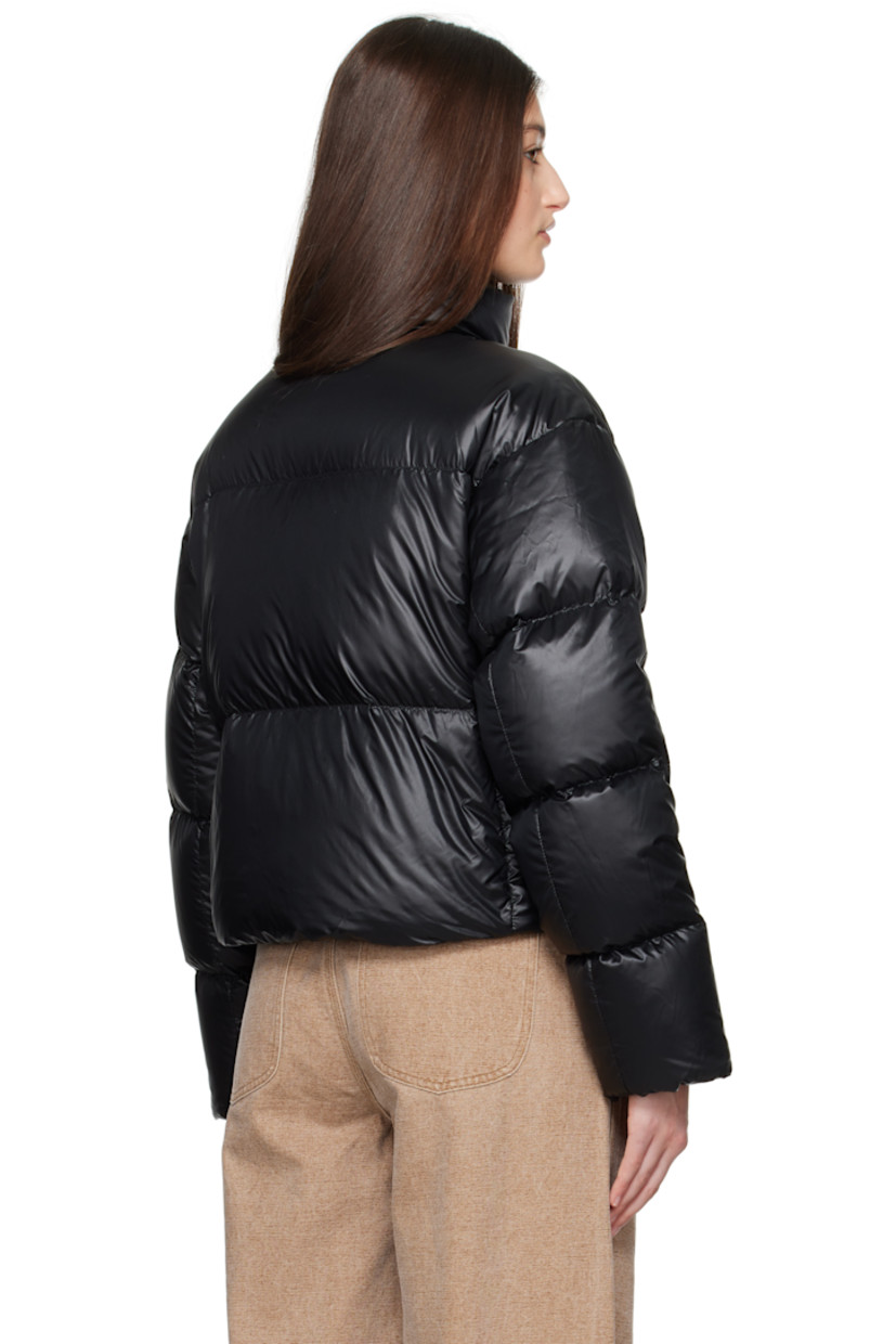 Down-filled and quilted recycled nylon ripstop jacket. Packable, lightweight, water-repellent, and wind-resistant.

· Stand collar
· Two-way zip closure with button placket
· Seam pockets
· Bungee-style drawstring at cropped hem
· Dropped shoulders
· Embroidered logo patch at sleeve
· Inset rib-knit cuffs
· Detachable logo-woven shoulder straps at interior
· Welt and zip pocket at interior
· Mesh patch pockets at interior
· Full satin lining

Supplier color: Black

 Fill: 90% duck down, 10% down feather.