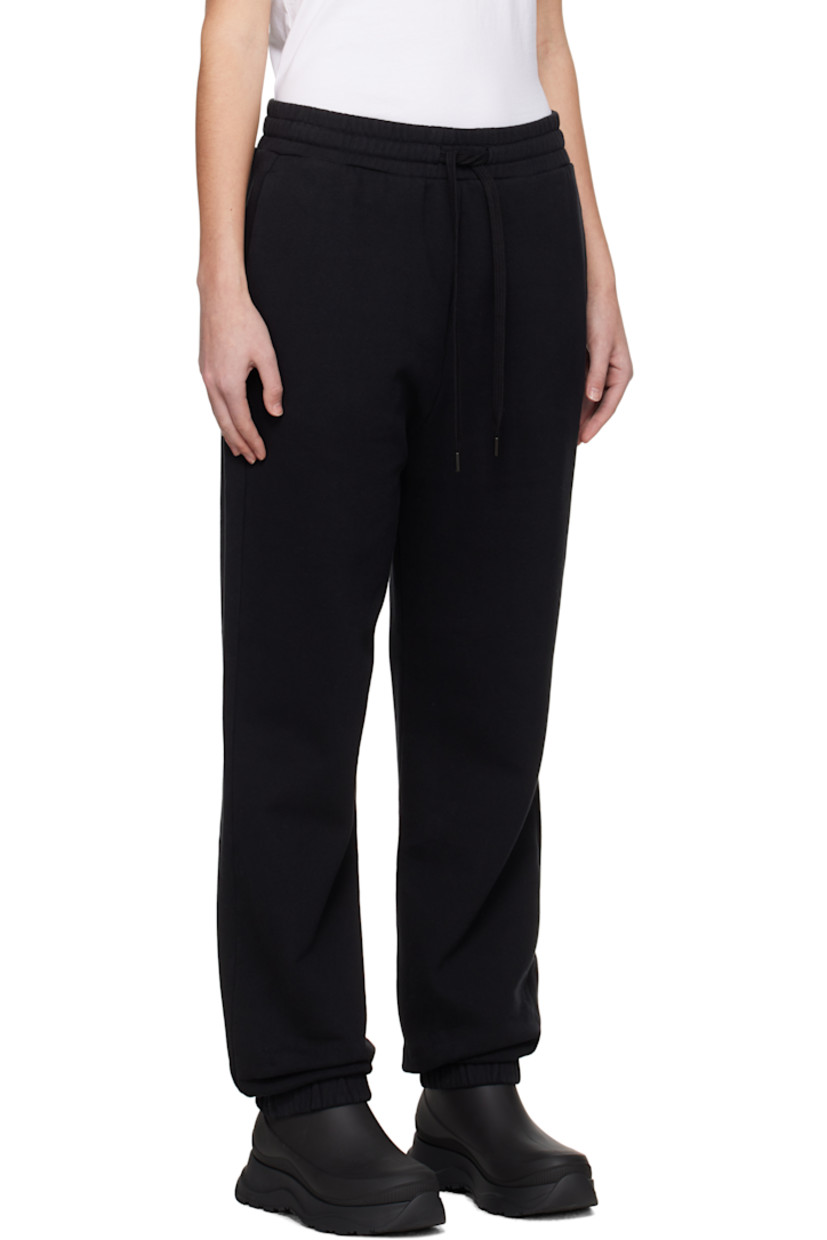Cotton fleece sweatpants.

· Drawstring at elasticized waistband 
· Two-pocket styling
· Rubberized logo patch at front
· Elasticized cuffs

Supplier color: Black