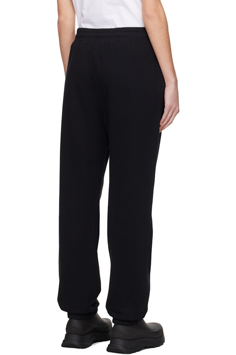 Cotton fleece sweatpants.

· Drawstring at elasticized waistband 
· Two-pocket styling
· Rubberized logo patch at front
· Elasticized cuffs

Supplier color: Black