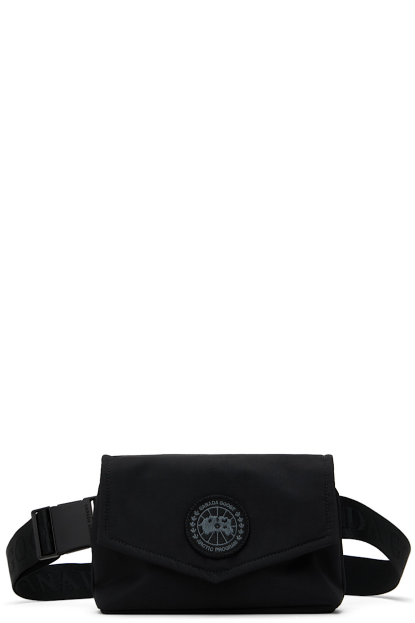 Insulated CORDURA® nylon duck canvas belt bag in black.

· Water-repellent and durable
· Adjustable logo-woven crossbody strap
· Embroidered logo patch at face
· Press-stud flap
· Zip closure
· Patch pocket at interior
· Quilted taffeta lining
· H5.5" x W8.5" x D1.75"

Supplier color: Black