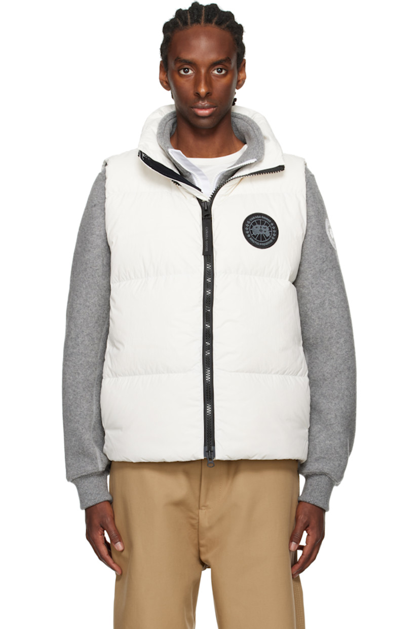Down-filled and quilted EnduraLuxe recycled nylon taffeta vest. Lightweight and water-repellent.

· RDS-certified down
· Stand collar
· Logo-woven zip-pull at two-way zip closure
· Embroidered logo patch at chest
· Zip pockets 
· Reflective webbing strap at back collar
· Zip pocket at interior
· Full satin lining

Part of the Black Label collection.

Supplier color: North star white

Fill: 90% duck down, 10% duck feathers.