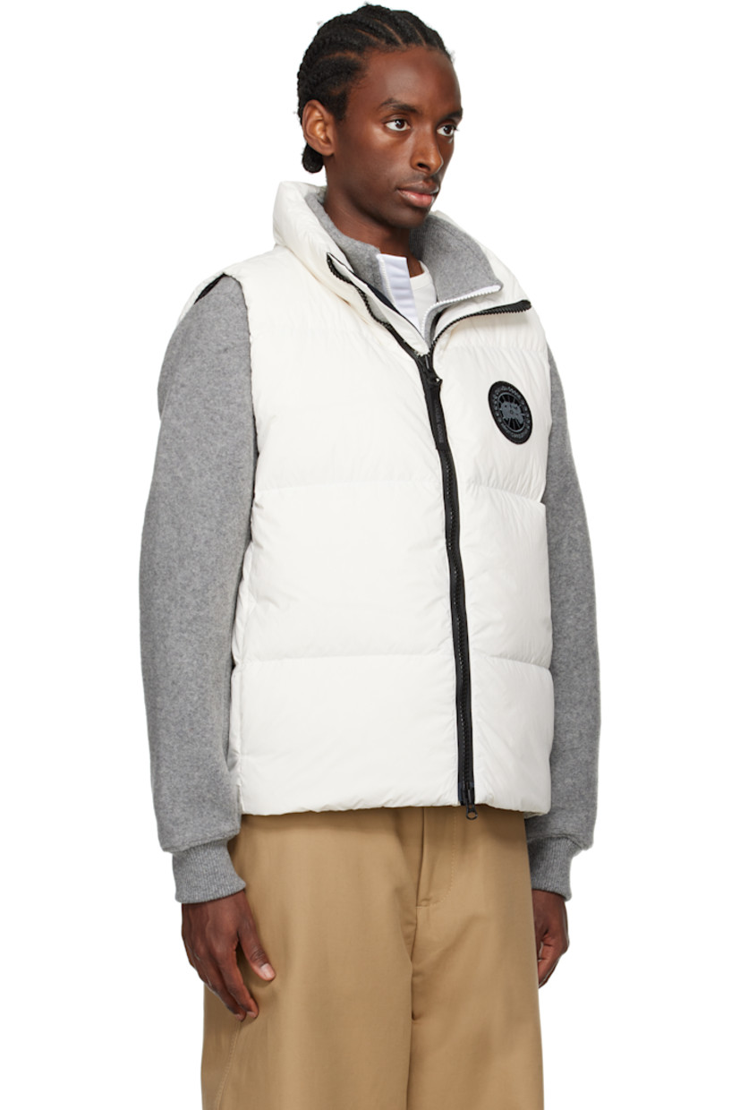 Down-filled and quilted EnduraLuxe recycled nylon taffeta vest. Lightweight and water-repellent.

· RDS-certified down
· Stand collar
· Logo-woven zip-pull at two-way zip closure
· Embroidered logo patch at chest
· Zip pockets 
· Reflective webbing strap at back collar
· Zip pocket at interior
· Full satin lining

Part of the Black Label collection.

Supplier color: North star white

Fill: 90% duck down, 10% duck feathers.