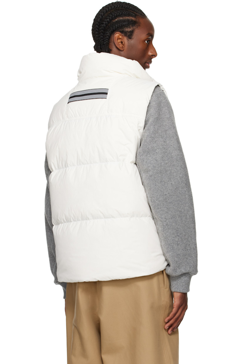 Down-filled and quilted EnduraLuxe recycled nylon taffeta vest. Lightweight and water-repellent.

· RDS-certified down
· Stand collar
· Logo-woven zip-pull at two-way zip closure
· Embroidered logo patch at chest
· Zip pockets 
· Reflective webbing strap at back collar
· Zip pocket at interior
· Full satin lining

Part of the Black Label collection.

Supplier color: North star white

Fill: 90% duck down, 10% duck feathers.