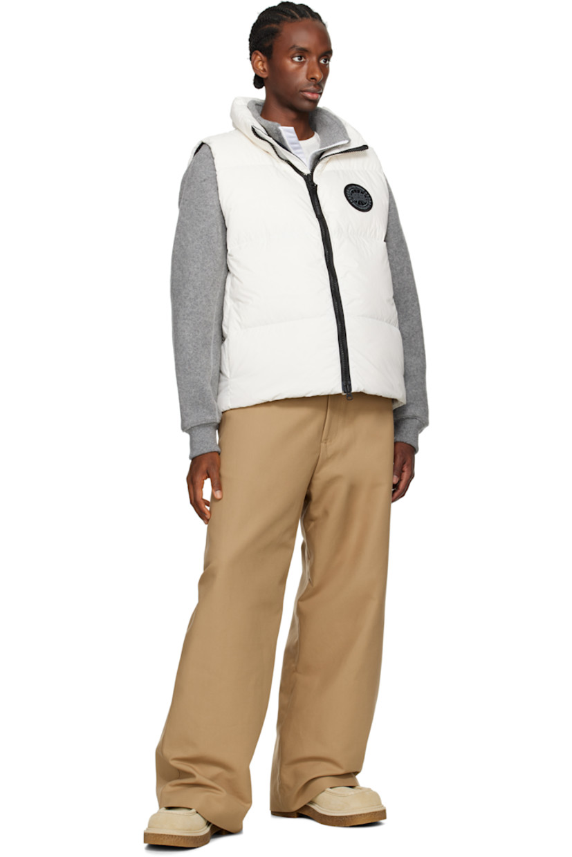 Down-filled and quilted EnduraLuxe recycled nylon taffeta vest. Lightweight and water-repellent.

· RDS-certified down
· Stand collar
· Logo-woven zip-pull at two-way zip closure
· Embroidered logo patch at chest
· Zip pockets 
· Reflective webbing strap at back collar
· Zip pocket at interior
· Full satin lining

Part of the Black Label collection.

Supplier color: North star white

Fill: 90% duck down, 10% duck feathers.