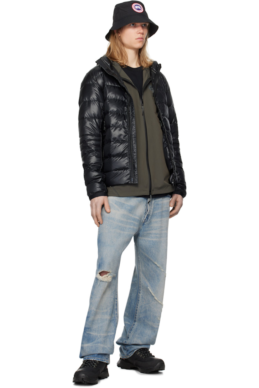 Packable down-filled quilted nylon ripstop jacket. Lightweight, water-repellent, and wind-resistant. 

· Bungee-style drawstring at hood
· Stand collar
· Two-way zip closure
· Zip pockets
· Concealed bungee-style drawstring at hem
· Embroidered logo patch at sleeve
· Power Stretch® jersey cuffs
· Detachable elasticized shoulder straps at interior
· Fully lined

Part of the Black Label collection.

Supplier color: Black

Fill: 90% duck down, 10% duck feather.