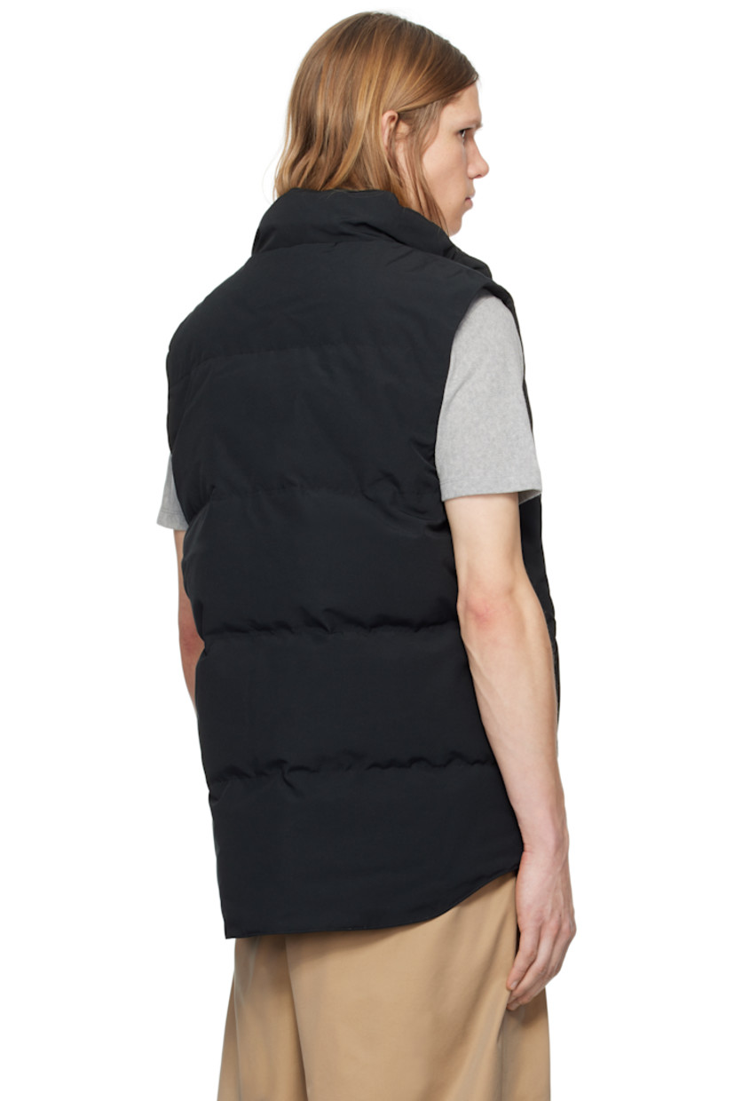 Down-filled quilted Arctic Tech® polyester- and cotton-blend duck canvas vest. Water-repellent.

· Stand collar
· Two-way zip closure with press-stud placket
· Embroidered logo patch at chest
· Welt pockets
· Droptail hem
· Zip pocket at interior
· Full satin lining

Part of the Black Label collection.

Supplier color: Black

Fill: 80% duck down, 20% duck feather.