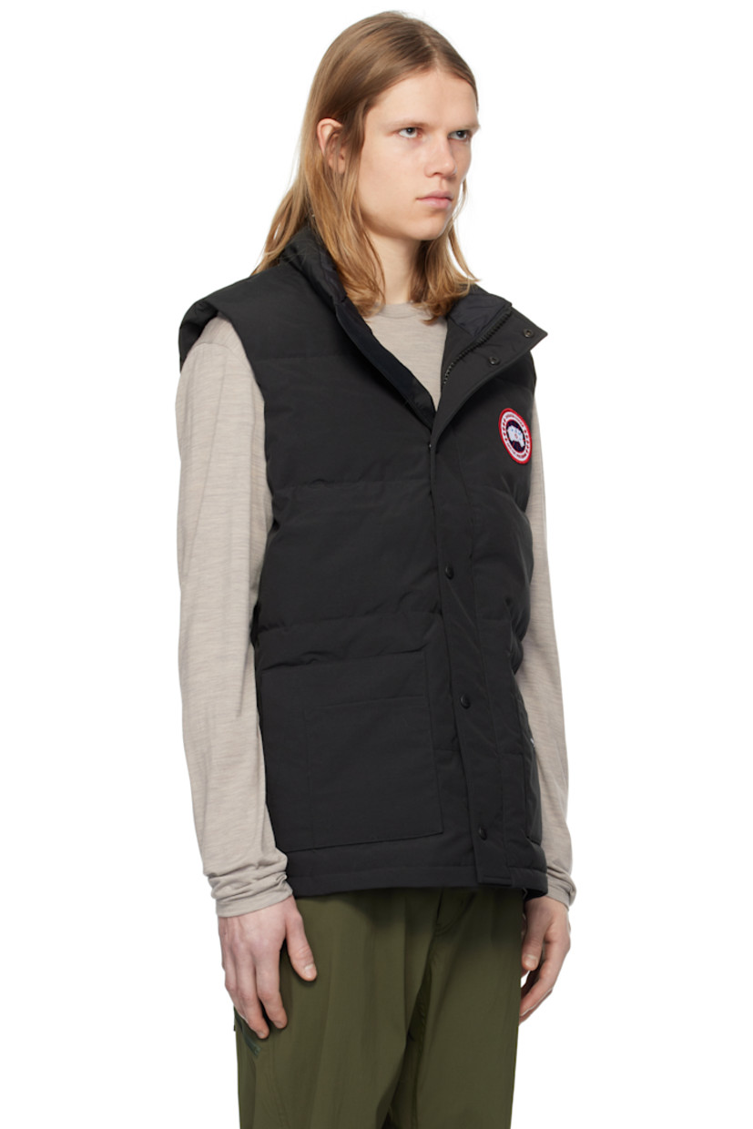 Down-filled quilted Arctic Tech® polyester- and cotton-blend canvas vest. Water-repellent.

· Stand collar
· Zip closure with press-stud placket
· Embroidered logo patch at chest
· Patch pockets and welt pockets
· Logo patch at front 
· Zip pocket at interior
· Full satin lining

Supplier color: Black

Fill: 80% duck down, 20% duck feather.