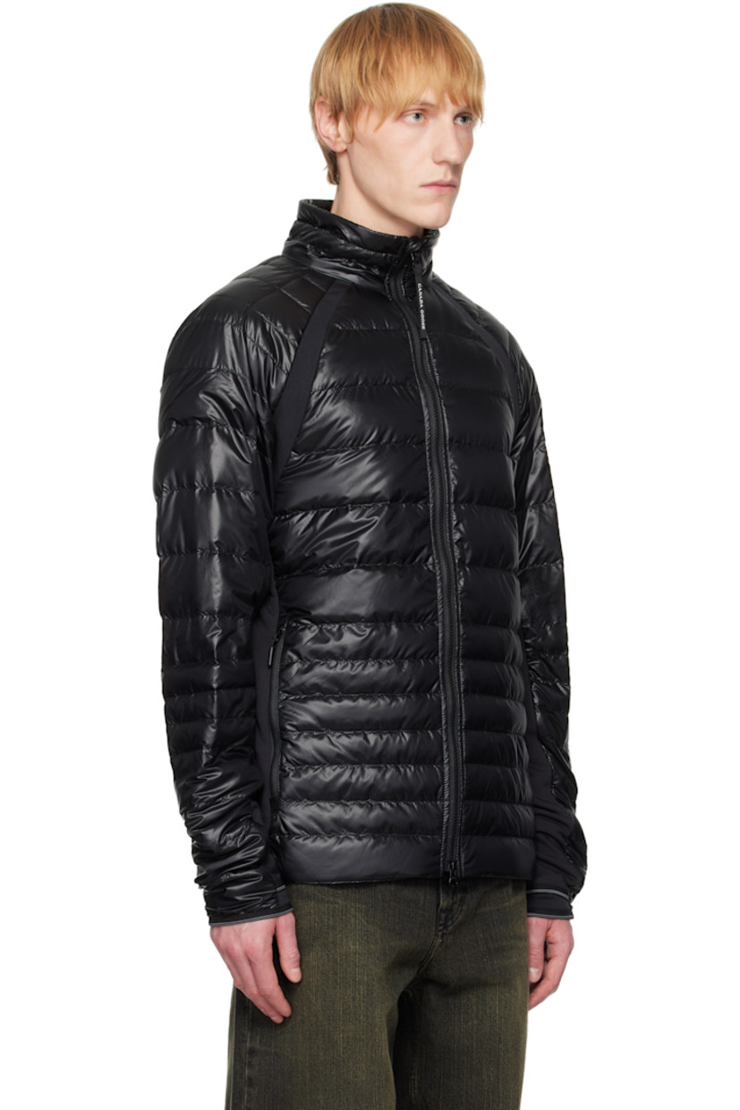 Packable down-filled and quilted stretch recycled nylon ripstop jacket. Stretch fleece panels throughout.

· Packs into waist pocket
· Lightweight, water-repellent, and wind-resistant
· Stand collar
· Two-way zip closure
· Zip pockets
· Raglan sleeves
· Embroidered logo patch at sleeve
· Elasticized cuffs
· Reflective trim at back collar
· Patch pockets at interior
· Full nylon satin lining

Supplier color: Black

Fill: 90% goose down, 10% goose feather.