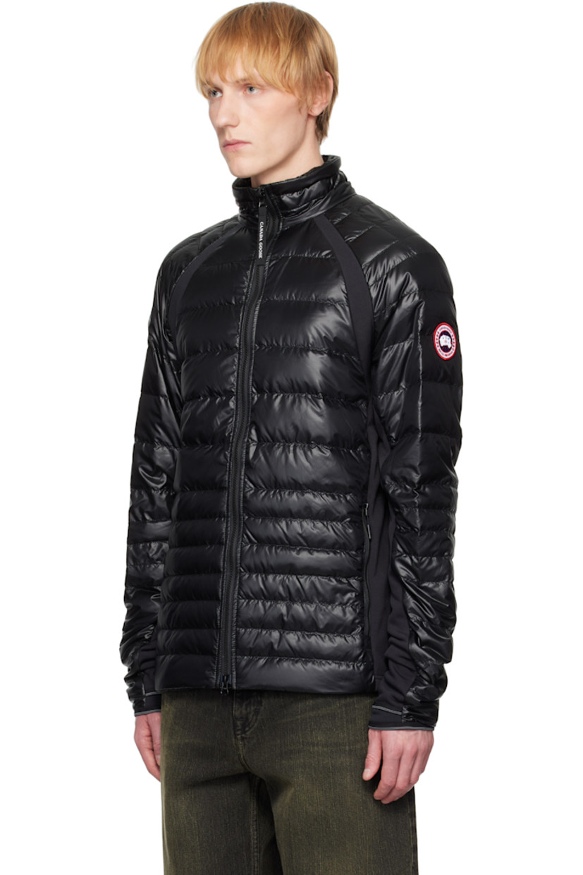 Packable down-filled and quilted stretch recycled nylon ripstop jacket. Stretch fleece panels throughout.

· Packs into waist pocket
· Lightweight, water-repellent, and wind-resistant
· Stand collar
· Two-way zip closure
· Zip pockets
· Raglan sleeves
· Embroidered logo patch at sleeve
· Elasticized cuffs
· Reflective trim at back collar
· Patch pockets at interior
· Full nylon satin lining

Supplier color: Black

Fill: 90% goose down, 10% goose feather.
